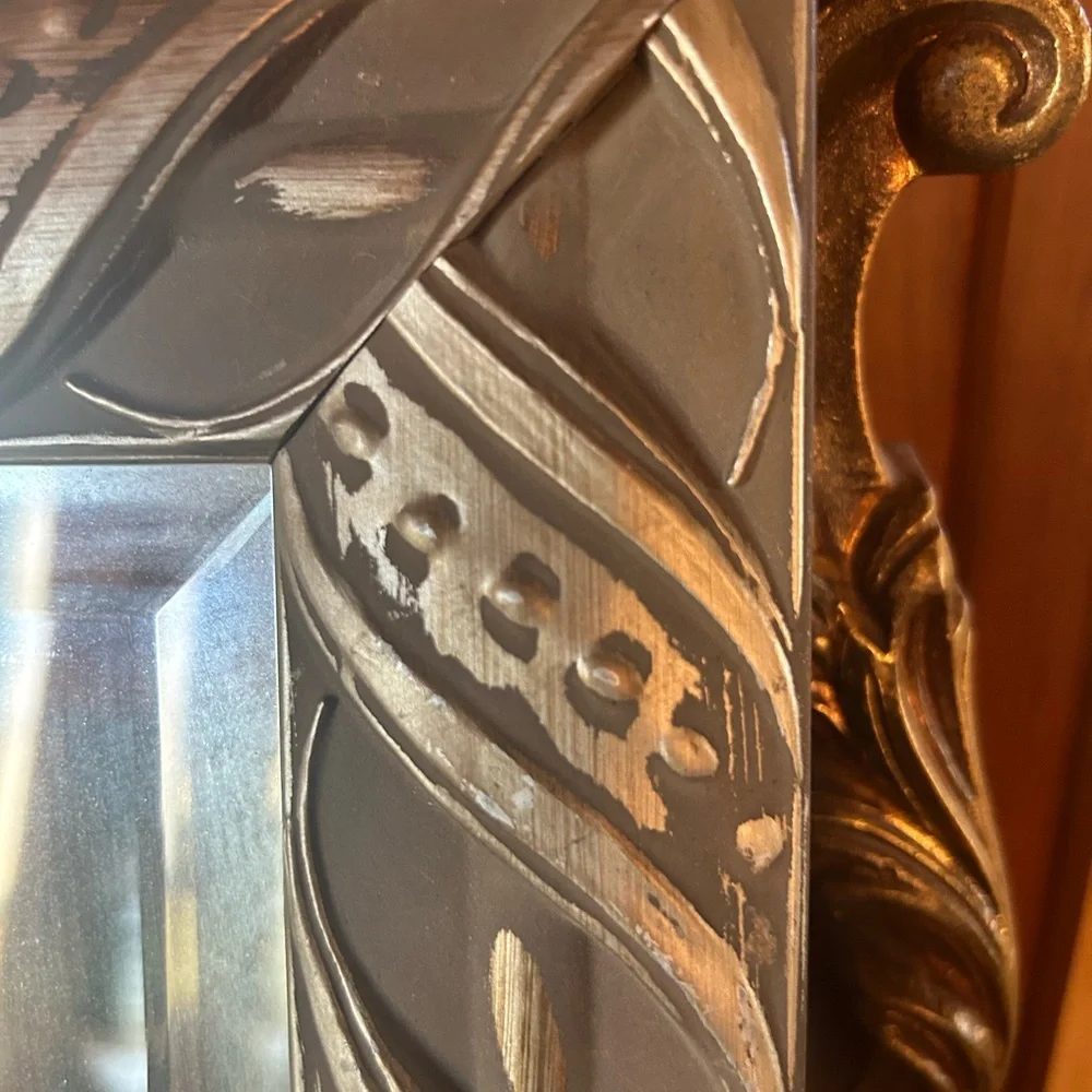 Silver framed mirror with beveled mirror. Good vintage condition.
